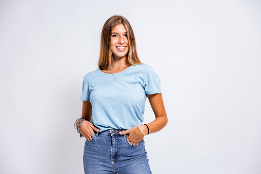 One teenage girl posing on white background for a studio shot.