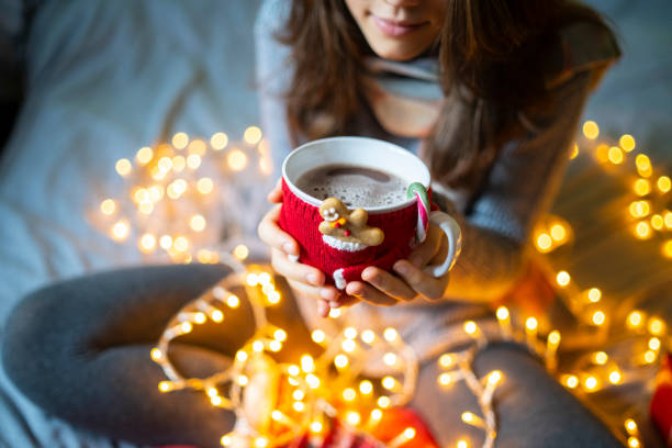 istock A mug in a mug cosy with coffee inside being held by a person 1344972142