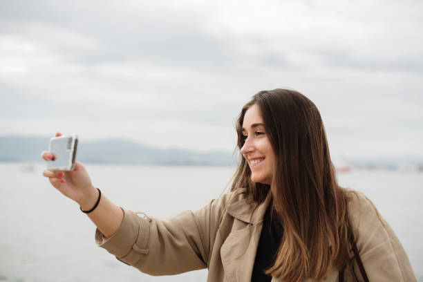 istock Young woman taking a selfie with a smart phone 1344972149