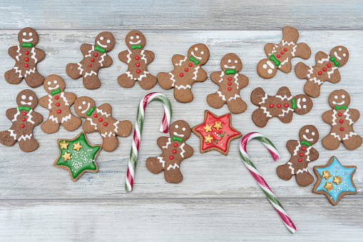 Colorful Christmas sweets and sugar lollipops over white rustic board. Top vew.
