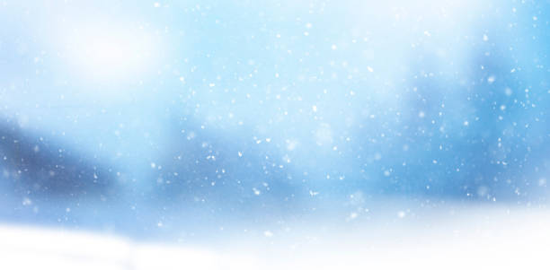 istock Blurred snowy background with snowflakes 1344973129