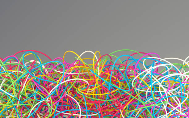 istock Big amount of tangled colored cables on a gray background 1344973352