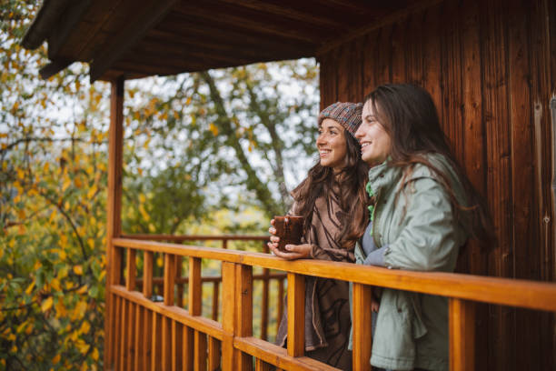 istock Two Young Women Drinking Tea On The Porch 1344976299