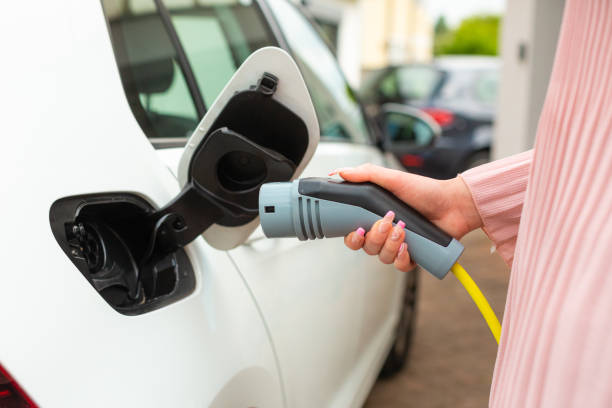 istock Plugging in electric car charger 1344977068