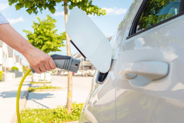 istock Female hands plugging in an EV charger 1344977123