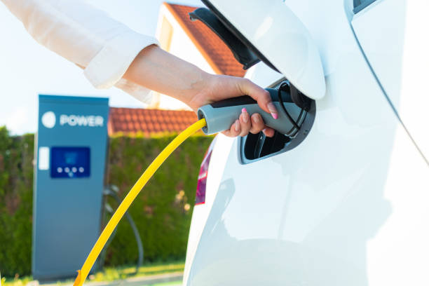 istock Plugging in electric car charger 1344977125