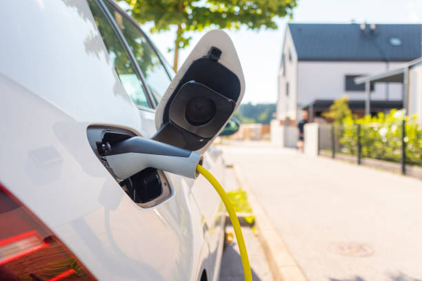 istock Electric car charger plugged in 1344977146