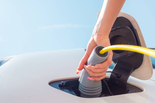 istock Plugging in electric car charger 1344977315