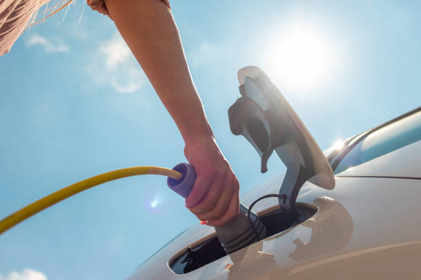 istock Electric car plugged in the charger 1344977318