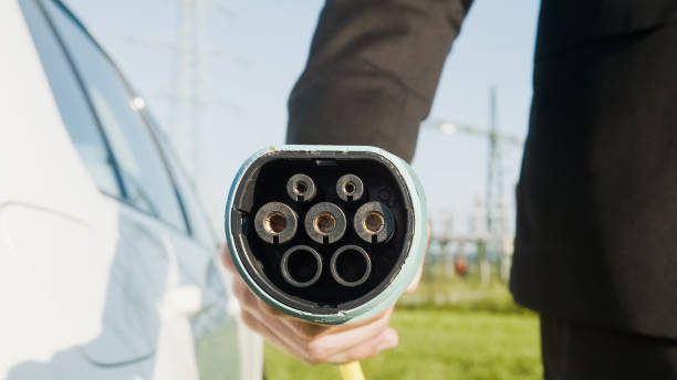 istock Businessman charging an electric car 1344977319