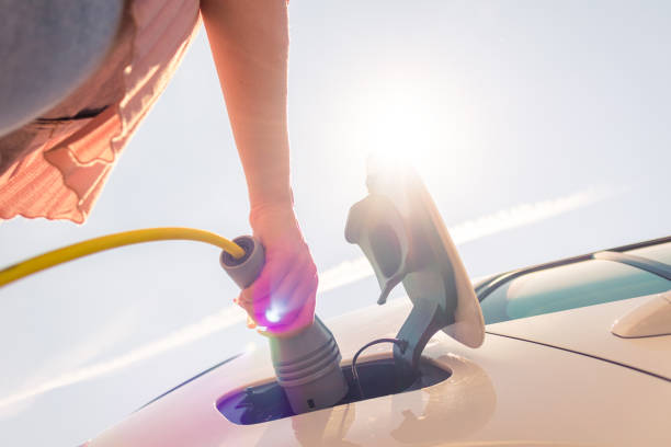 istock Electric car plugged in the charger 1344977326