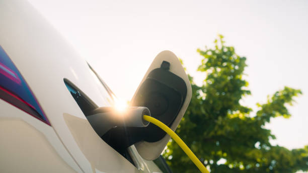 istock Electric car with charger plugged in 1344977880