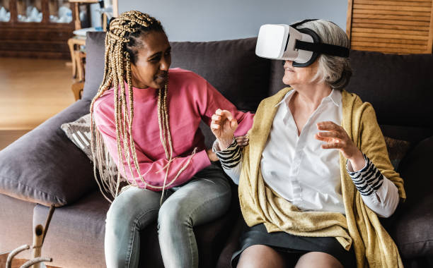istock Multigenerational women playing virtual reality console video games at home - VR tech trend - Focus on senior woman face 1344977961