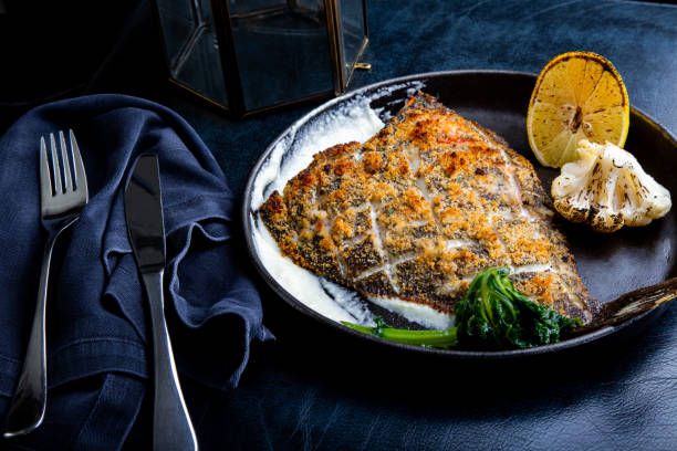 istock Flounder fillet roasted in a skillet with herbs and lemon 1344978484
