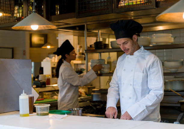 istock Chef cooking in the kitchen of a restaurant 1344979162