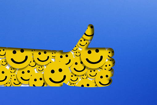 Happy smiley face emoticons in thumbs up shape, customer reviews concept