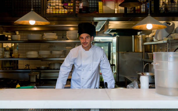istock Chef working in the kitchen of a restaurant and looking at the camera 1344979181