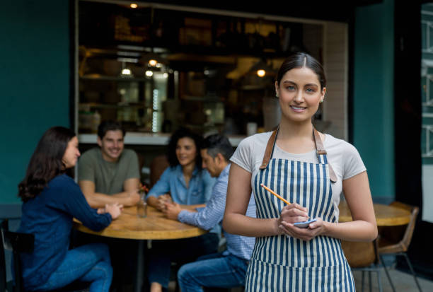 istock Beautiful waitress working at an outdoors restaurant 1344979216