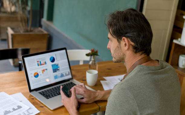 istock Business manager working at a restaurant doing the books on a laptop 1344979712
