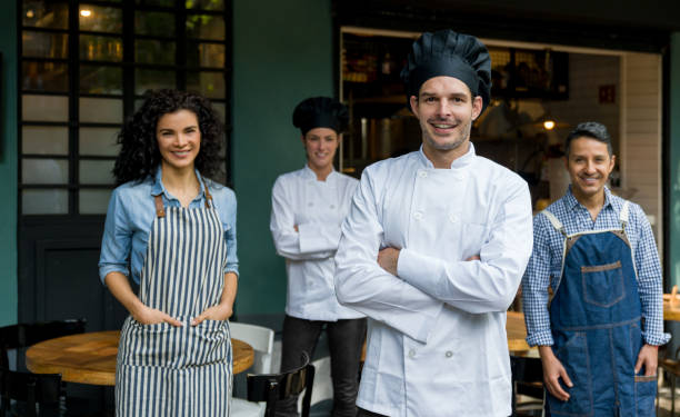 istock Chef looking very happy at the restaurant with his team 1344979801