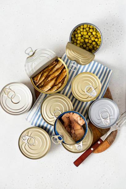 istock Different canned food on gray concrete background top view 1344980491