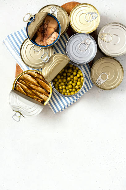 istock Different canned food on gray concrete background top view 1344980738