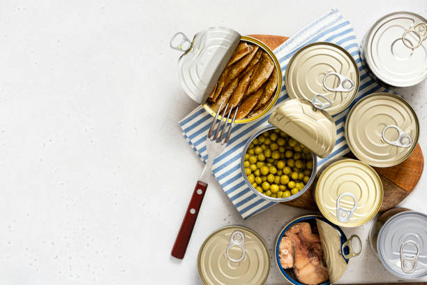 istock Different canned food on gray concrete background top view 1344981296