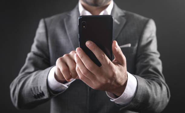 istock Caucasian businessman using smartphone in office. 1344983092