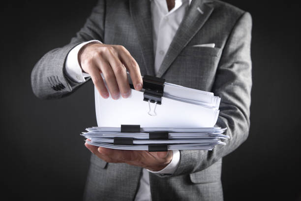 istock Caucasian businessman holding documents in office. 1344983098