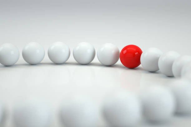 A green marble about to impact a row of blue marbles.