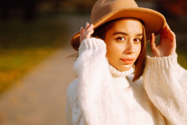 Young woman  resting in nature. Fashion, style concept. People, lifestyle, relaxation and vacations concept