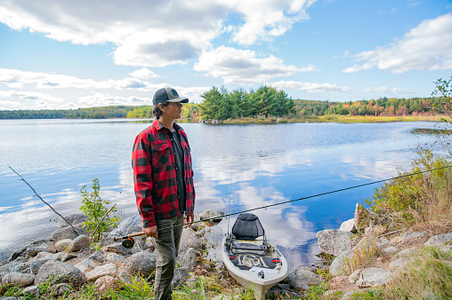 Fisherman angling on the river, trying to catch a trophy fish. Fishing, sport and recreation