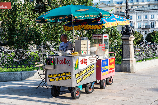 Warsaw, Poland - September 1, 2018: Vendor in its food stall of hot dog on a street in the old town of Warsaw, Poland
