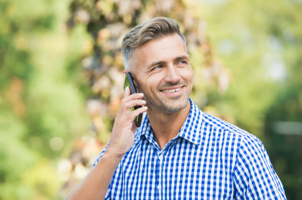 istock happy man speaking on mobile phone, modern life 1344988403