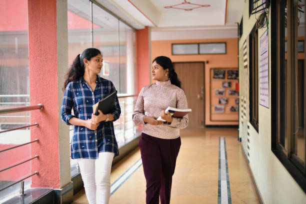 istock Teachers walking through School Corridor in a school 1344991357