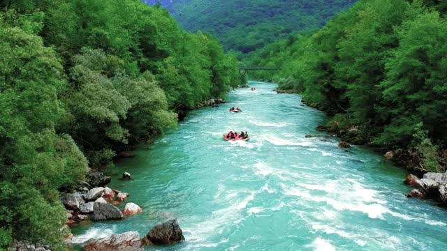 People in Inflatable Rafting Boats Riding Whitewater Rapids