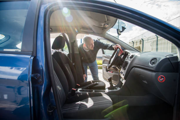 istock Young man cleaning the interior of a car 1344993804