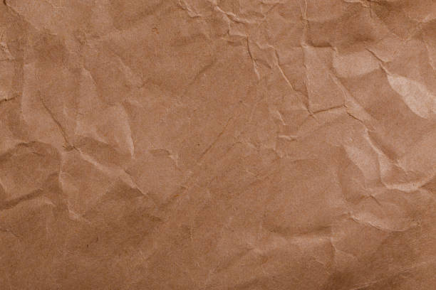 istock Ragged crumpled brown kraft paper texture and full frame background 1344996255