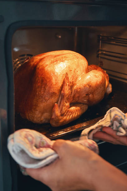 istock Roasting Turkey in the Oven for Holiday Dinner 1344996374