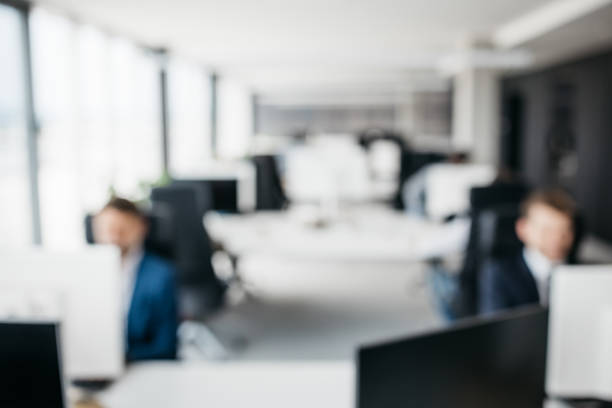 istock Blurred photo of co-workers in an office 1345003701