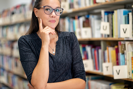 Young pensive woman portrait in a Library