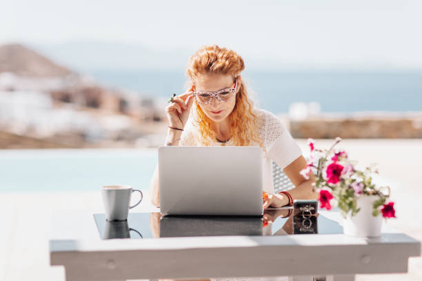 istock Business woman using laptop on terrace 1345007221