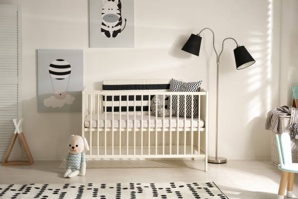 istock Cute baby room interior with crib and decor elements 1345007553