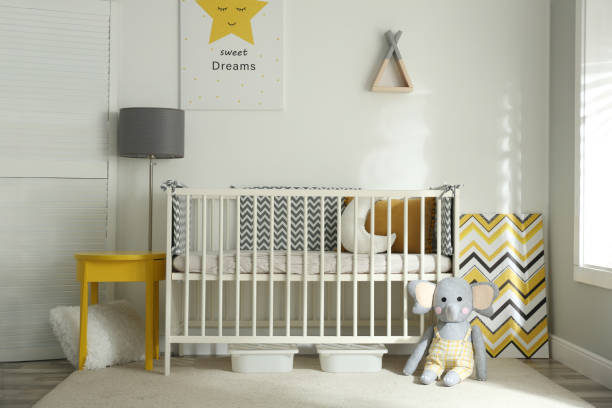 istock Cute baby room interior with crib and decor elements 1345007566