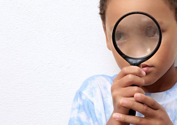 istock boy with magnifying glass ready to explore stock photo 1345008504