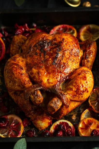 istock Baked appetizing whole chicken with oranges and cranberries in oven form. 1345010019