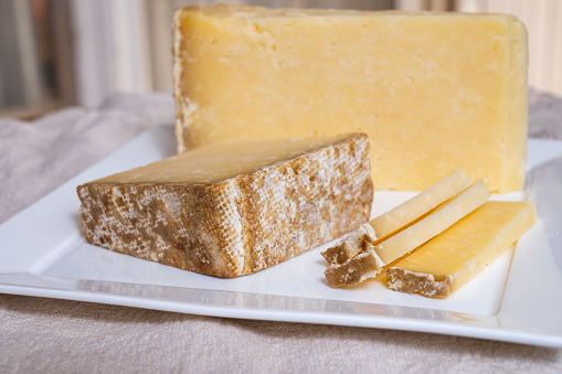 Cheese collection, hard French cheese old cantal fermier made from raw cow milk with rind close up