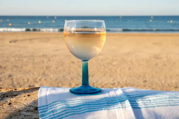 Photo of Summer time in Provence, drinking of cold gris rose wine on sandy beach and blue sea near Toulon, Var department, France