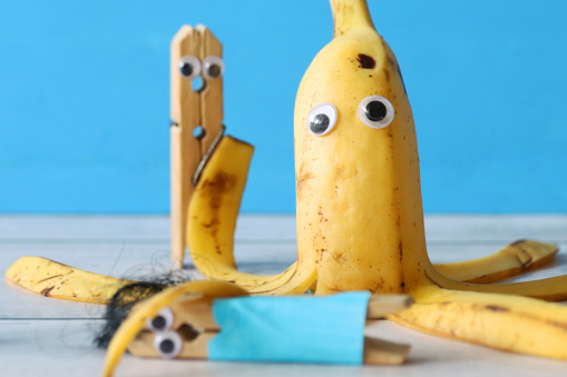 Stock photo showing a close-up view of ripe banana made into cartoon octopus with googly eyes and peel tentacles for a touch of humour. Fun way to encourage healthy eating in children.