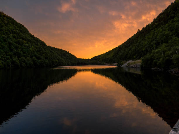 istock Pond with mountains in the sunset 1345012624